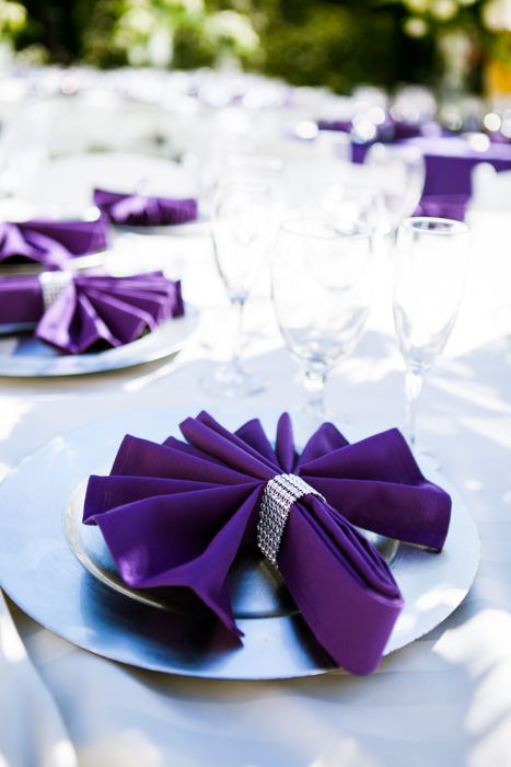 Purple napkin folded on a silver charger