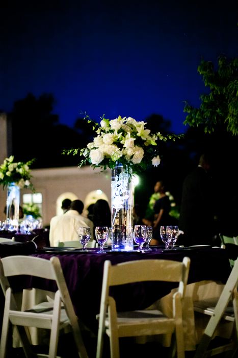 Evening reception tables lit under the trees