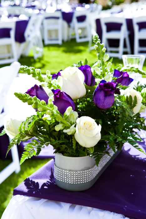 White and purple floral arrangement on a reception table