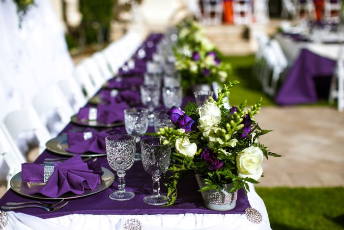 Banquet table with purple runner and crystal glassware