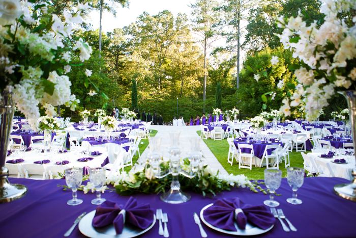 Outdoor reception with purple linens and white floral centerpieces