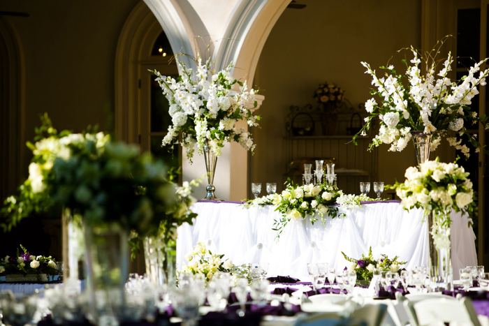 Head table with tall white floral arrangements
